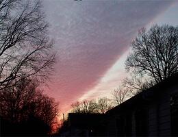 The same clouds - At a different position with the sun lower in the sky.