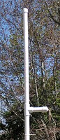 JaxWeather Lightning Detector Installation - 1-wire lightning detector (Hobby-Boards) and 1 1/4 inch PVC Pipe housing. Materials list: 1 10 foot 1 1/4 inch PVC pipe, 1 1 1/4 TEE, 3 1 1/4 Caps. The 18" antenna is in the upper section of PVC pipe. The lightning detector is mounted in the short horizontal leg. Access to both areas is by removable PVC caps. Lower section is empty pipe for mounting and the cap on the bottom leg has a small hole drilled to allow any condensation to drain. (c) 2006 JaxWeather